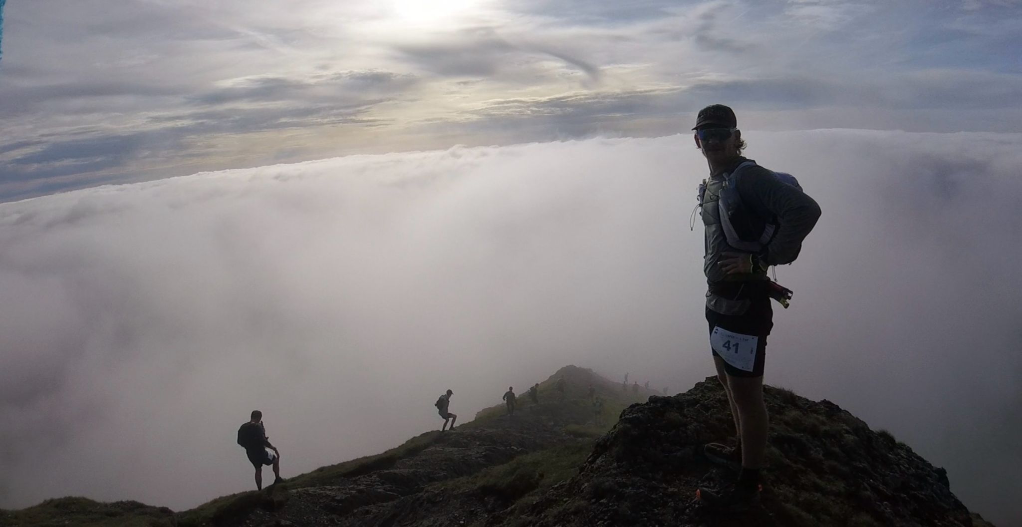 Philip, Gary, and Simon stand on top of a misty mountain peak